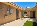 Private outdoor patio with secure gate, artificial grass, seating and charming string lights at 6035 N 9Th Ave, Phoenix, AZ 85013