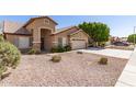 A single-story tan home featuring desert landscaping and a two-car garage at 8343 W Paradise Dr, Peoria, AZ 85345