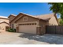 A single-story home with a desert rock yard and a two-car garage at 8343 W Paradise Dr, Peoria, AZ 85345