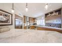 Contemporary kitchen with a large marble island, stainless steel appliances, and custom wood cabinetry at 8880 E Paraiso Dr # 120, Scottsdale, AZ 85255