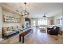 Bright and airy living room with modern lighting, travertine floors, and comfortable seating areas at 8880 E Paraiso Dr # 120, Scottsdale, AZ 85255