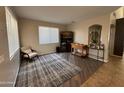 Cozy living room with neutral colors, a patterned rug, and stylish decor at 10347 W Odeum Ln, Tolleson, AZ 85353