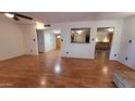 Open living room with laminate wood flooring, neutral paint, open doorway, and ample natural light at 1103 E Palmcroft Dr, Tempe, AZ 85282