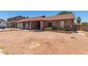 A single story brick home with desert landscaping around the front yard at 1123 W Mendoza Ave, Mesa, AZ 85210