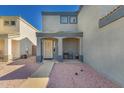 Charming covered front porch with seating area, neutral tones, desert landscaping, and mature landscaping at 12325 W Dreyfus Dr, El Mirage, AZ 85335