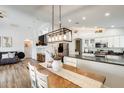 Bright open-concept living space with a dining table, modern lighting, and a spacious kitchen at 1397 E Laurel Pl, Casa Grande, AZ 85122