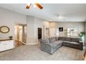 Comfortable living room with a plush gray sectional sofa and neutral decor at 1397 E Laurel Pl, Casa Grande, AZ 85122