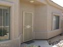 Close-up view of the home's front door and windows showing stucco exterior and desert landscaping at 14214 N Galatea Dr # A, Fountain Hills, AZ 85268