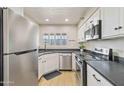 Bright kitchen with stainless steel appliances, white cabinetry, and window for natural light at 154 W 5Th St # 246, Tempe, AZ 85281