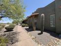 Sidewalk on the front of the home, lined with drought-resistant vegetation and small rocks at 15523 W Peakview Rd, Surprise, AZ 85387