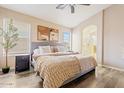 Serene bedroom with wood floors, neutral palette, and a luxurious comfortable bed at 16586 W Latham St, Goodyear, AZ 85338