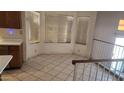 Kitchen dining area featuring tile floors and multiple windows for natural light at 17458 N 64Th Dr, Glendale, AZ 85308