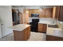 A cozy kitchen featuring oak cabinets, an island, and stainless steel appliances at 17458 N 64Th Dr, Glendale, AZ 85308