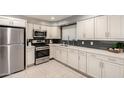 Beautiful kitchen featuring stainless steel appliances, white cabinets, and tile floors at 1747 W Devon --, Mesa, AZ 85201