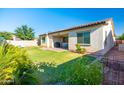 An immaculate backyard featuring a covered patio and lush green lawn at 19598 E Walnut Rd, Queen Creek, AZ 85142