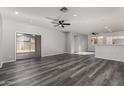 Spacious living room featuring modern gray wood floors and lots of natural light at 20919 E Desert Hills Blvd, Queen Creek, AZ 85142