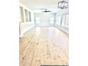Spacious living room with light wood flooring, recessed lights, and multiple windows at 2114 N 94Th Ave, Phoenix, AZ 85037