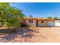 Charming single-story home with gravel yard and mature trees under a clear blue sky at 2138 W Northview Ave, Phoenix, AZ 85021