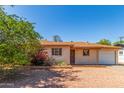 Charming single-story home with gravel yard and mature trees under a clear blue sky at 2138 W Northview Ave, Phoenix, AZ 85021