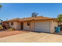 Charming single-story home with long driveway and attached garage under a clear blue sky at 2138 W Northview Ave, Phoenix, AZ 85021