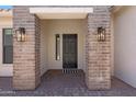 Elegant front door with brick columns and stylish lighting, offering a warm welcome at 2859 E Los Altos Rd, Gilbert, AZ 85297