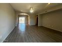 Spacious open-concept living room with neutral paint, ceiling fan, recessed lighting, and modern tile flooring at 3935 E Rough Rider Rd # 1282, Phoenix, AZ 85050