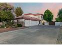 Spacious three-car garage featuring a full driveway, and a two-story home at 3955 E Fox Cir, Mesa, AZ 85205