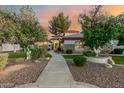 Beautiful single-story home with stone accents, mature trees, and a walkway leading to the front door at 3955 E Fox Cir, Mesa, AZ 85205