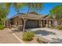 Single-story home features desert landscaping with a two-car garage at 4241 E Bonanza Rd, Gilbert, AZ 85297