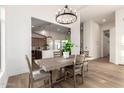 Elegant dining room area with rustic wood table, stylish chandelier, and open view to the kitchen at 5426 E Karen Dr, Scottsdale, AZ 85254