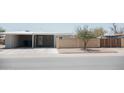 Charming single-story home with two-car carport, block fence, and minimalist landscaping at 5602 W Heatherbrae Dr, Phoenix, AZ 85031