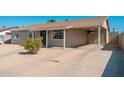 View of the side and front of this single-story home featuring a carport at 5951 W Granada Rd, Phoenix, AZ 85035