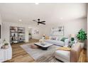Bright living room with hardwood floors, modern furnishings, and a ceiling fan at 5951 W Granada Rd, Phoenix, AZ 85035