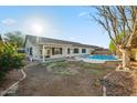 Spacious backyard featuring a refreshing in-ground swimming pool, covered patio, and low-maintenance landscaping at 6805 S 14Th St, Phoenix, AZ 85042