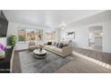 Bright and airy living room featuring stylish furniture, neutral tones, and abundant natural light at 6805 S 14Th St, Phoenix, AZ 85042