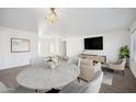 Bright open-concept living space featuring stylish furniture, neutral tones, and dining area creating a comfortable atmosphere at 6805 S 14Th St, Phoenix, AZ 85042