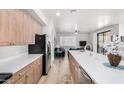 Open concept kitchen with stainless steel appliances and a view of the living area at 705 W Queen Creek Rd # 2062, Chandler, AZ 85248