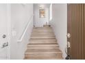 Bright, well-lit staircase with light wood flooring and a modern handrail at 705 W Queen Creek Rd # 2062, Chandler, AZ 85248