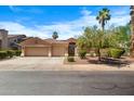Beige home with a terracotta roof, two-car garage, and well-manicured front yard landscaping at 786 E Coconino Dr, Chandler, AZ 85249