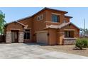 Stunning two-story house featuring a terracotta exterior, a garage, and stone accents at 833 S 113Th Ave, Avondale, AZ 85323