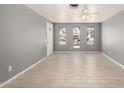 An open living room offers tile floors and light grey walls and natural light at 10115 W Turney Ave, Phoenix, AZ 85037