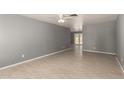 An open living room offers tile floors and light grey walls at 10115 W Turney Ave, Phoenix, AZ 85037