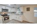 Updated kitchen showcasing white cabinets, modern hardware, and stylish backsplash at 11014 W Cocopah St, Avondale, AZ 85323