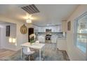 Eat-in kitchen with white cabinets, stainless steel appliances, and gray wood-look floors at 11014 W Cocopah St, Avondale, AZ 85323