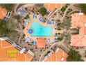 Aerial view of community pool with chairs, landscaping, and nearby homes at 11375 E Sahuaro Dr # 2033, Scottsdale, AZ 85259