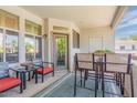 View of the balcony with outdoor chairs and table, and a patio door at 11375 E Sahuaro Dr # 2033, Scottsdale, AZ 85259
