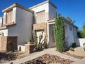 Charming home exterior with desert landscaping, rock beds, a stone accent wall and shutters at 1257 E Voltaire Ave, Phoenix, AZ 85022