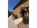 Charming home exterior with a walkway, decorative rock landscaping, and a stylish front entrance at 1350 S Greenfield Rd # 1221, Mesa, AZ 85206