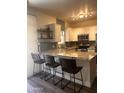 Bright kitchen with white cabinets, stainless steel appliances, granite countertops, and stylish bar seating at 1350 S Greenfield Rd # 1221, Mesa, AZ 85206