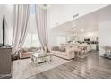 Open-concept living and dining area with elegant furnishings and soaring ceilings at 15006 N 172Nd Ln, Surprise, AZ 85388